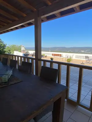 a table and chairs on a balcony with a view of the beach at Casa da azinheira in Loulé