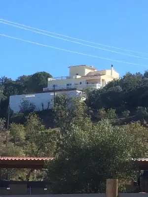 a large white building on top of a hill at Casa da azinheira in Loulé
