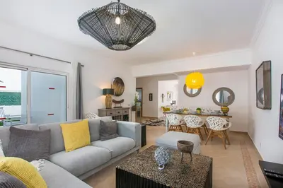 a living room with a couch and a table at Villas Mar e Brisa in Albufeira