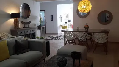 a living room with a couch and a table at Villas Mar e Brisa in Albufeira