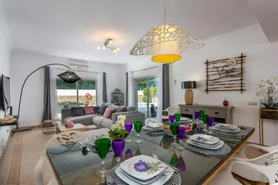a living room with a table and a couch at Villas Mar e Brisa in Albufeira