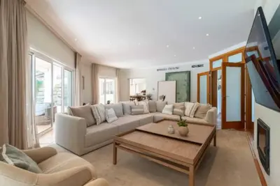 a living room with a couch and a coffee table at Villa Mayfair - Quinta do Lago in Almancil