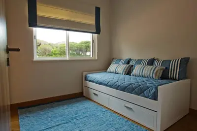 a bed in a room with a window at Villa Mayfair - Quinta do Lago in Almancil
