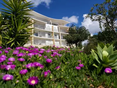 a building with purple flowers in front of it at Sunny Apartment with sea view in Albufeira in Albufeira