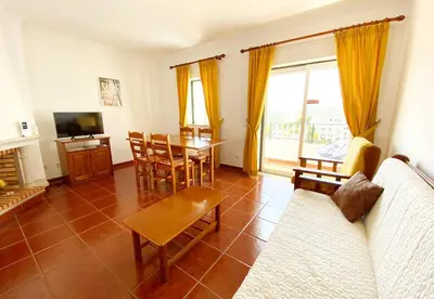 a living room with a couch and a table at Apartamento Carvalhal in Quarteira