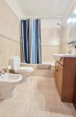 a bathroom with a toilet and a sink at Apartamento Carvalhal in Quarteira