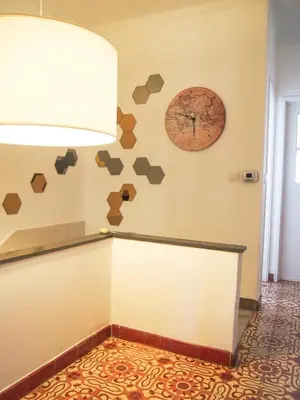 a room with a wall with a clock on it at Alagoa Terrace Guesthouse in Faro