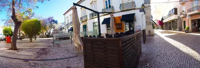 a building on a city street with a fence at Alagoa Terrace Guesthouse in Faro