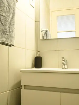 a bathroom with a sink and a mirror at Alagoa Terrace Guesthouse in Faro