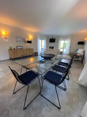a room with chairs and a table and a living room at Casa Corais in Guia