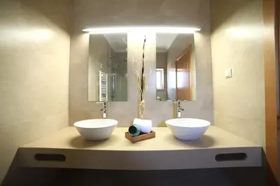 a bathroom with two white bowls on a counter at Casa Coralea in Guia