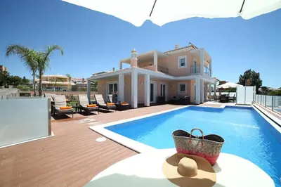 a villa with a swimming pool and a house at Casa Coralea in Guia