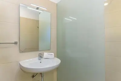 a bathroom with a sink and a mirror at FLH Faro Central House with Terrace in Faro