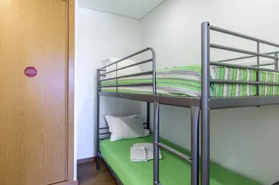 a bunk bed in a room with a green mattress at FLH Faro Central House with Terrace in Faro