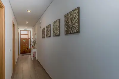 a hallway with four paintings on the wall at FLH Faro Central House with Terrace in Faro
