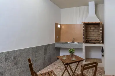 a kitchen with a table and chairs and a sink at FLH Faro Central House with Terrace in Faro