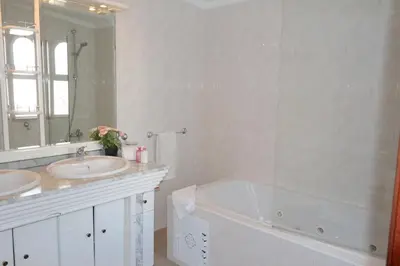 a bathroom with two sinks and a tub and a mirror at Vila Girasol, 171 - Clever Details in Vilamoura