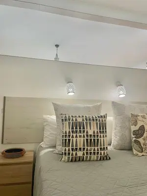 a bedroom with a bed with pillows on it at Bayview Apartment 106 in Albufeira