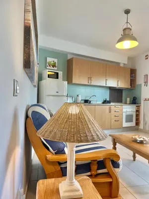 a table and chairs in a kitchen with a table at Bayview Apartment 106 in Albufeira