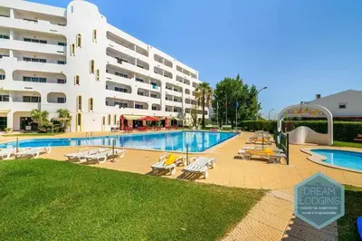 a large building with a swimming pool next to a hotel at Casa Branca 409 - Dream Lodging in Albufeira