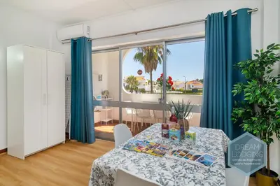 a dining room with a table and a large window at Casa Branca 409 - Dream Lodging in Albufeira