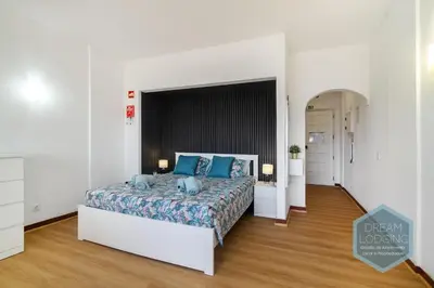 a bedroom with a large bed with blue pillows at Casa Branca 409 - Dream Lodging in Albufeira