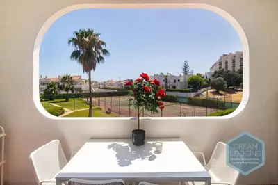 a table with a vase with a flower on it at Casa Branca 409 - Dream Lodging in Albufeira