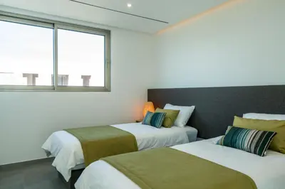 two beds in a room with two windows at Victoria Lux by SAPvillas in Vilamoura