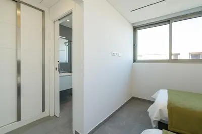 a bedroom with white walls and a window and a bed at Victoria Lux by SAPvillas in Vilamoura