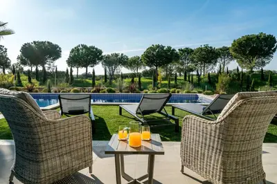 a patio with chairs and a table with orange juice at Victoria Lux by SAPvillas in Vilamoura