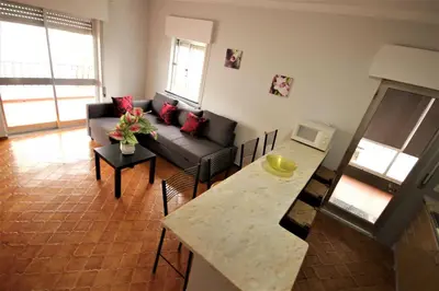 a living room with a couch and a table at Apartamento Brás in Quarteira