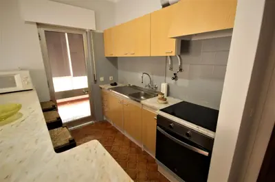 a small kitchen with a sink and a stove at Apartamento Brás in Quarteira