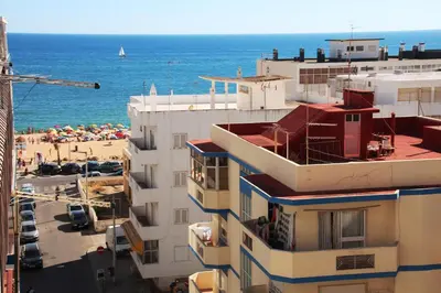 a building with a view of a beach and the ocean at Apartamento Brás in Quarteira