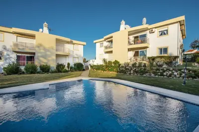a swimming pool in front of two houses at Apt Galé Garden AA by Algarve Villa Holidays in Albufeira