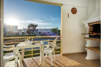 a patio with a table and chairs on a balcony at Apt Galé Garden AA by Algarve Villa Holidays in Albufeira