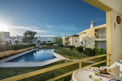 a swimming pool in a yard next to a building at Apt Galé Garden AA by Algarve Villa Holidays in Albufeira