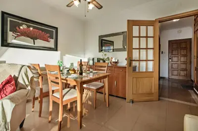 a kitchen and dining room with a table and chairs at Apt Galé Garden AA by Algarve Villa Holidays in Albufeira