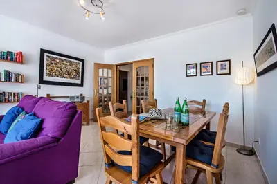 a living room with a table and a purple couch at Apt O Monte AG by Algarve Villa Holidays in Albufeira