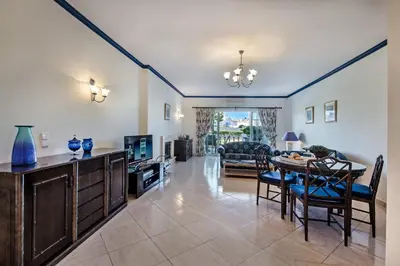 a living room with a table and a dining room at Apt O Monte C near the beach by Algarve Villa Holidays in Albufeira