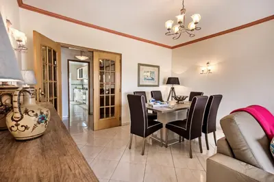 a dining room with a table and black chairs at Apt O Monte S by Algarve Villa Holidays in Galé