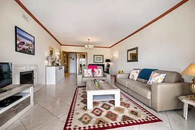 a living room with a couch and a table at Apt O Monte S by Algarve Villa Holidays in Galé
