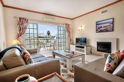 a living room with two couches and a fireplace at Apt O Monte S by Algarve Villa Holidays in Galé