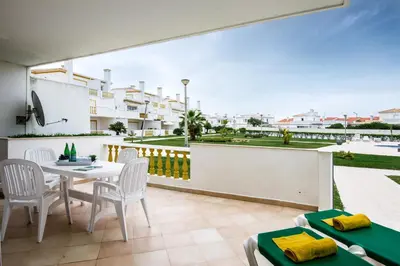 a patio with a table and chairs on a balcony at Apt O Monte S by Algarve Villa Holidays in Galé