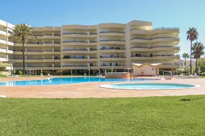 a swimming pool in front of a large apartment building at Apt Galé Mar 11 by Algarve Villa Holidays in Galé