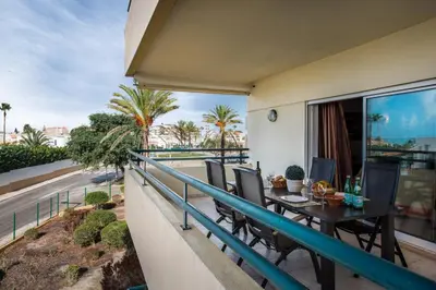 a balcony of a house with a table and chairs at Apt Galé Mar 11 by Algarve Villa Holidays in Galé