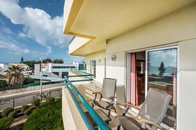 a balcony with two chairs and a view of a street at Apt Galé Mar 11 by Algarve Villa Holidays in Galé