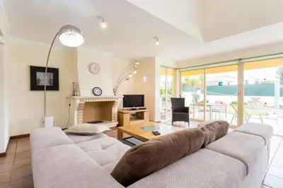 a living room with a couch and a fireplace at Helmar by Algarve Villa Holidays in Galé