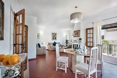 a kitchen and living room with a table and chairs at Íris by Algarve Villa Holidays in Galé