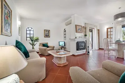 a living room with a couch and a fireplace at Íris by Algarve Villa Holidays in Galé