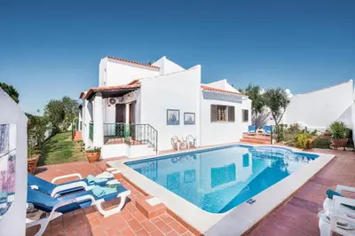 a villa with a swimming pool and a house at Íris by Algarve Villa Holidays in Galé
